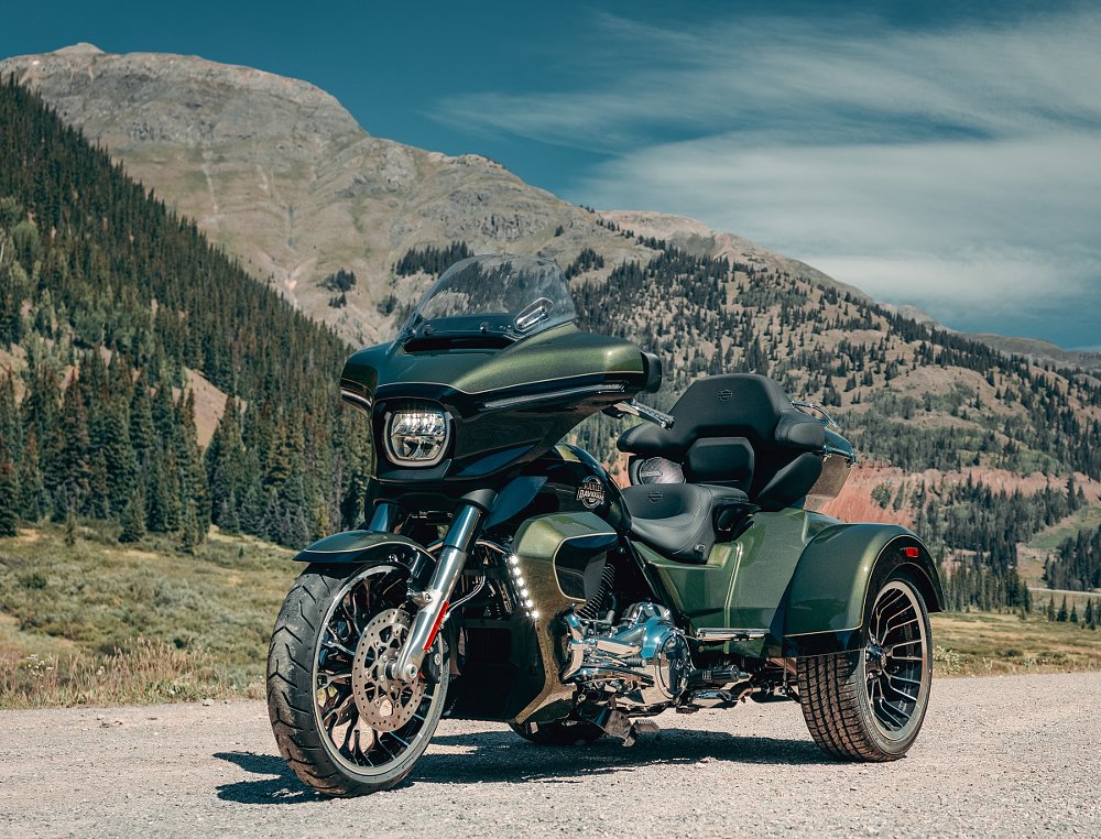 two riders on the trike on an open road
