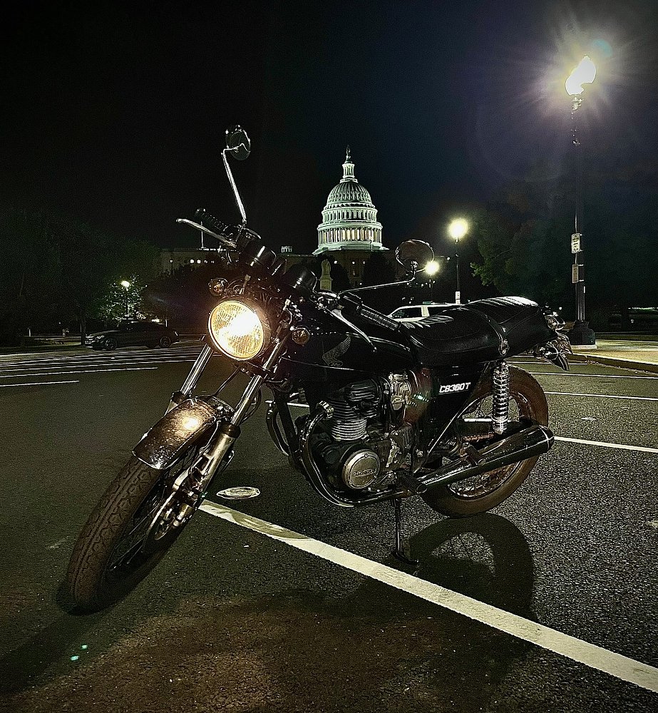 the black Honda CB360T at night in D.C. with the capitol dome lit up in the background