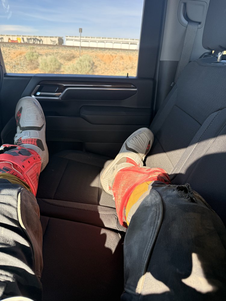lying in the back seat of a car on the way to the hospital, driving through the desert