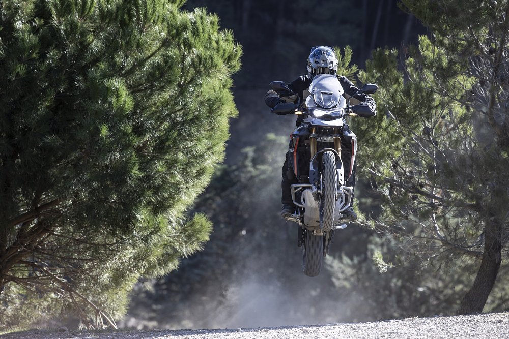 Tiger 900 Rally in the air over a jump off-road
